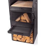 Trädgårdskamin i närbild med eld i eldstaden och termometer på ugnen.