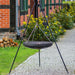 Tripod med hängande wok och vinschsystem från Cook King i trädgårdsmiljö